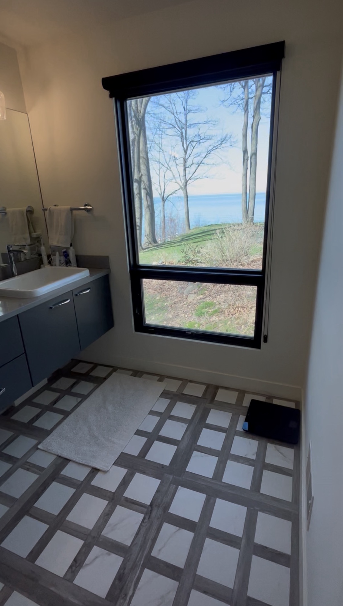 Bathroom with lake view window and marble tile floor